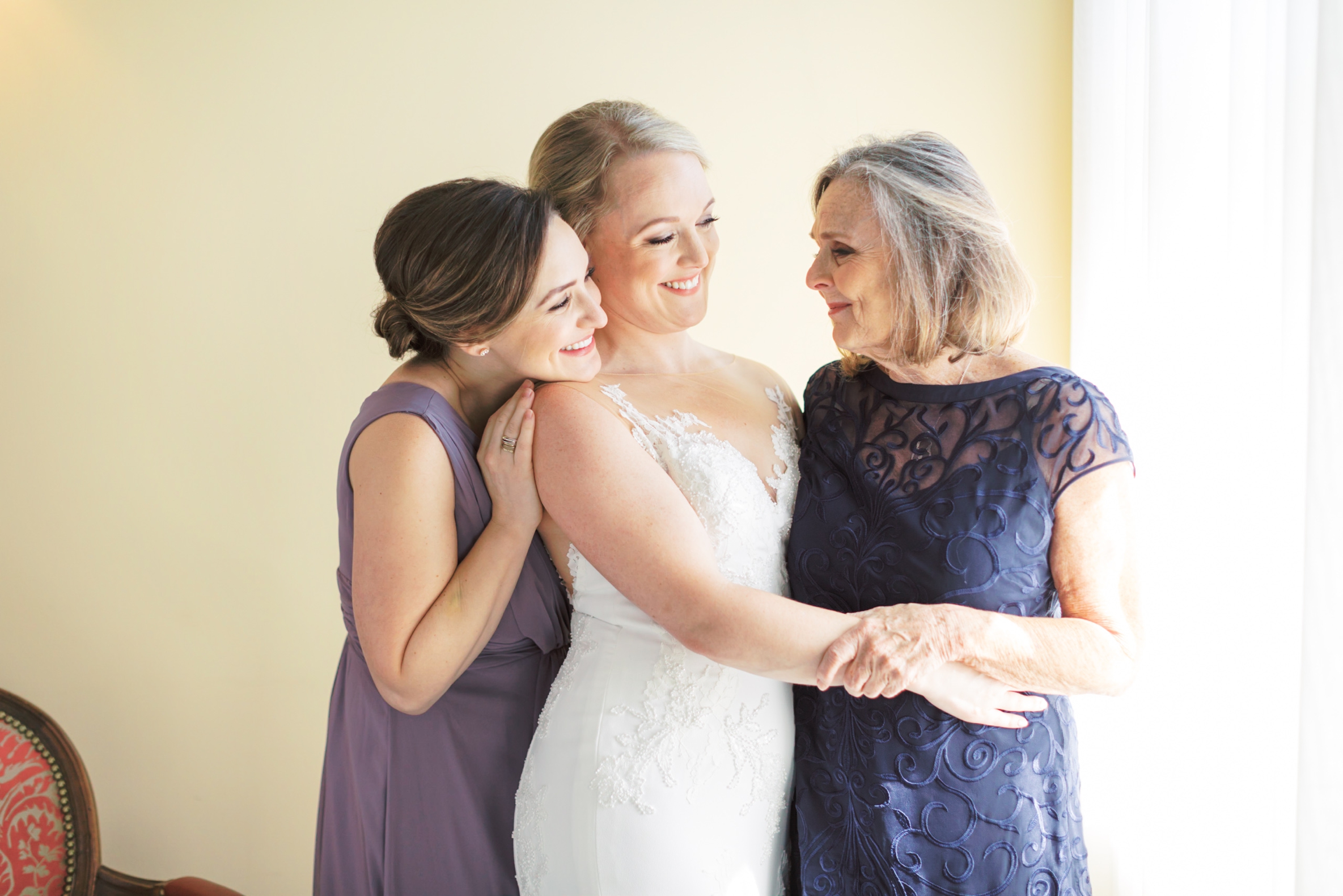 Bride hugging mom and sister, Cincinnati Wedding Photographer