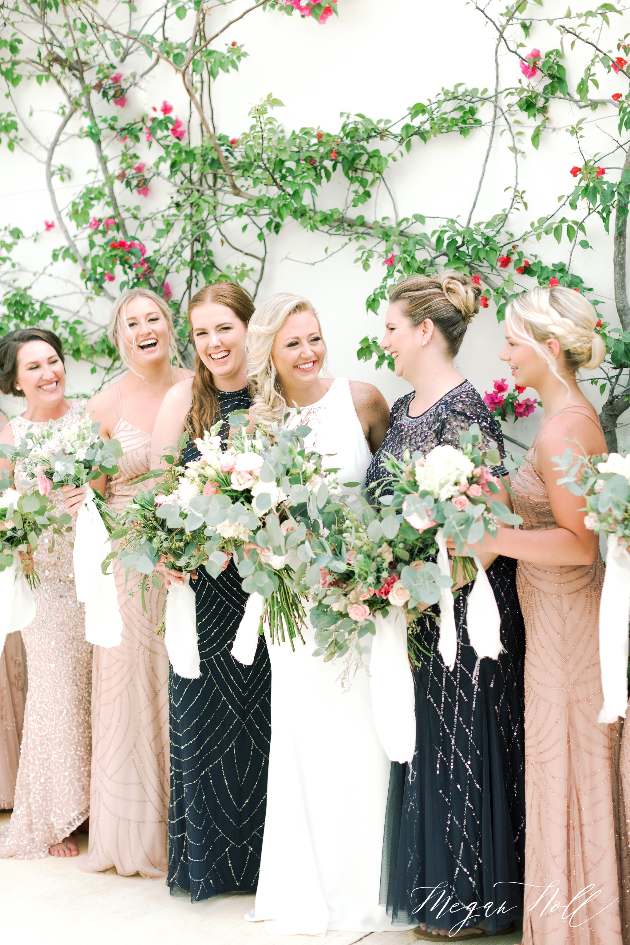 Bridesmaids lined up, holding bouquets in Cancun for a destination wedding