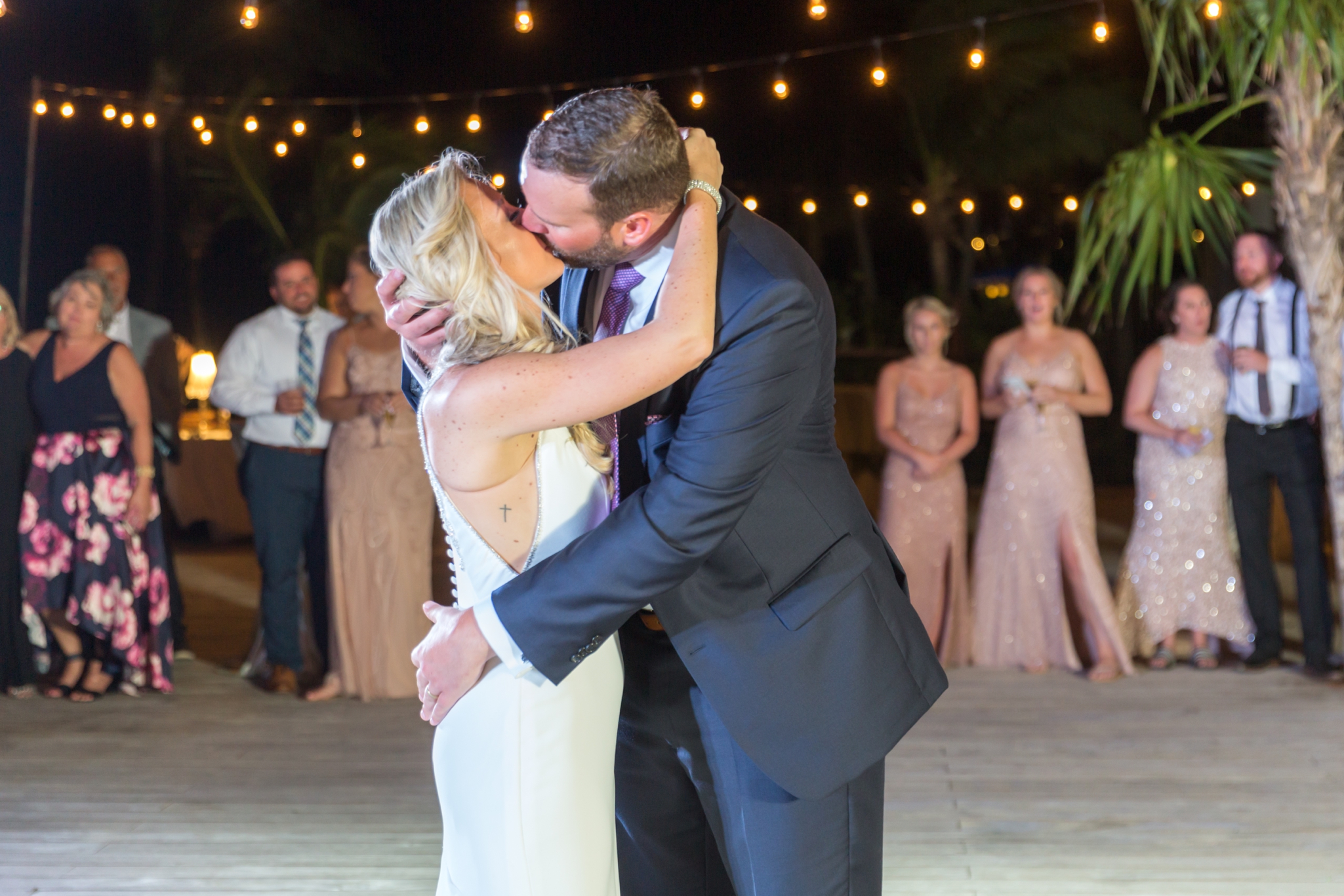 bride and groom share kiss during first dance