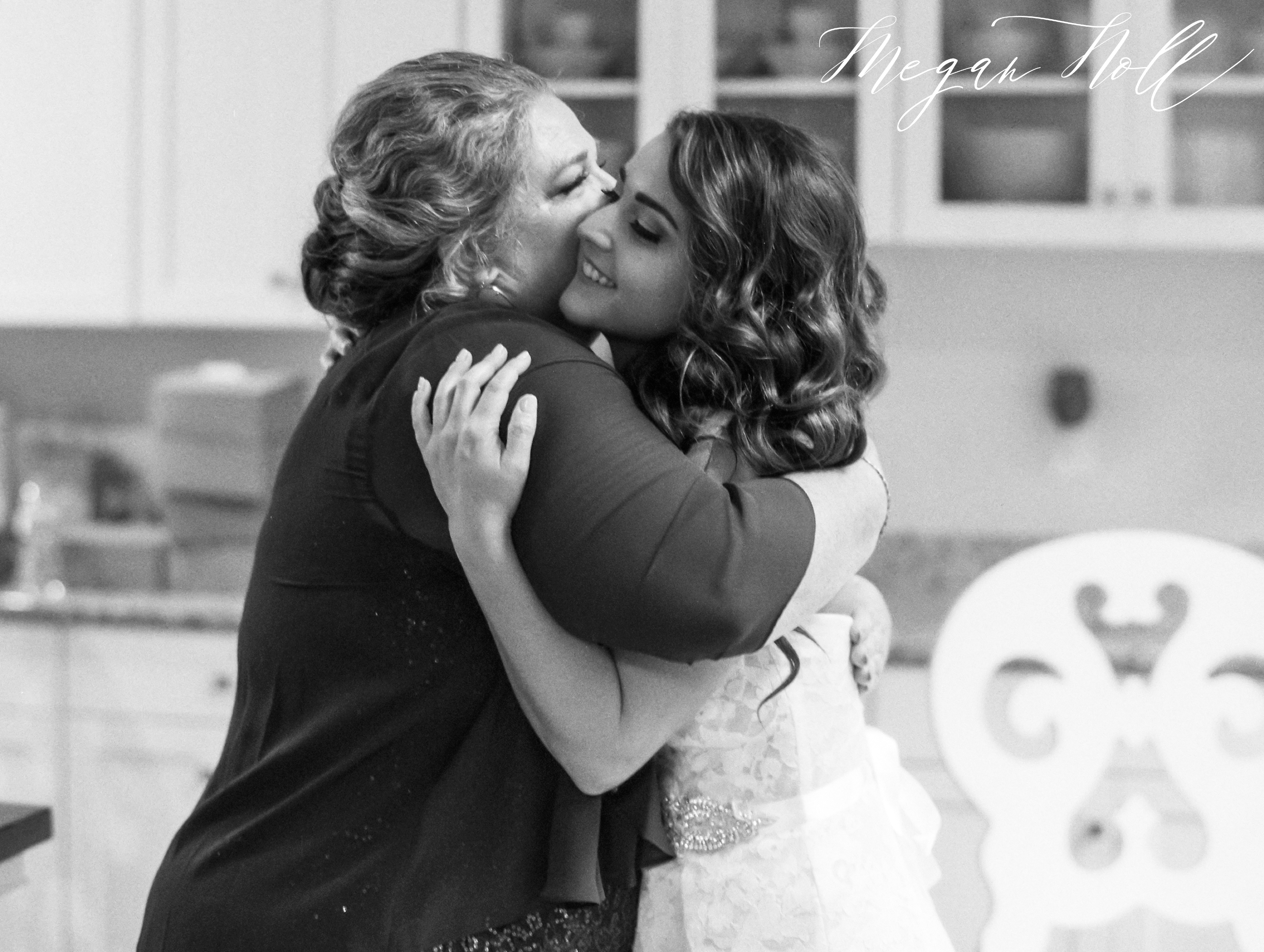Mother of the bride hugging bride in emotional embrace in Cincinnati Wedding