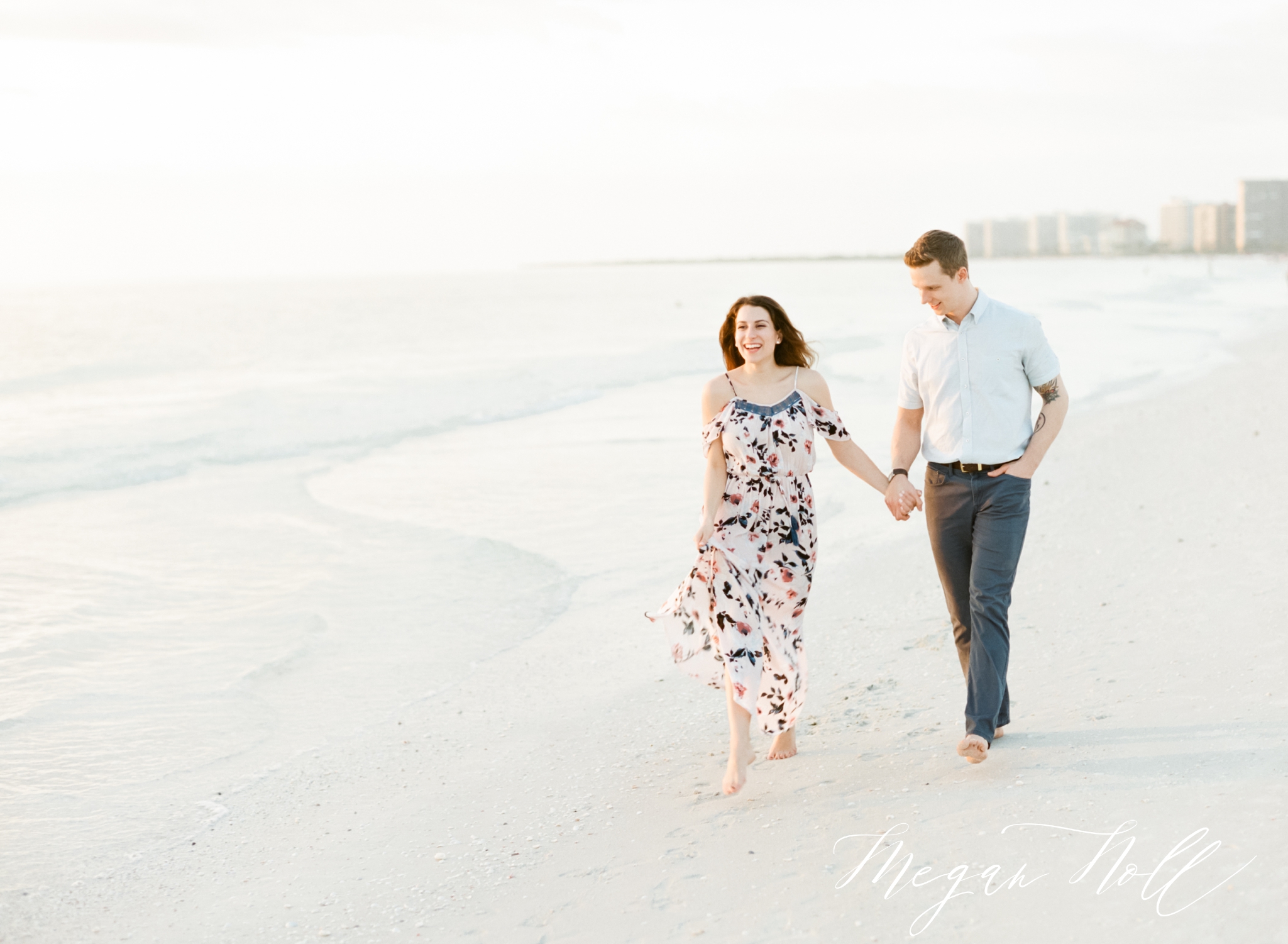 Walking on the beach at sunset, bride and groom posing for engagement pictures