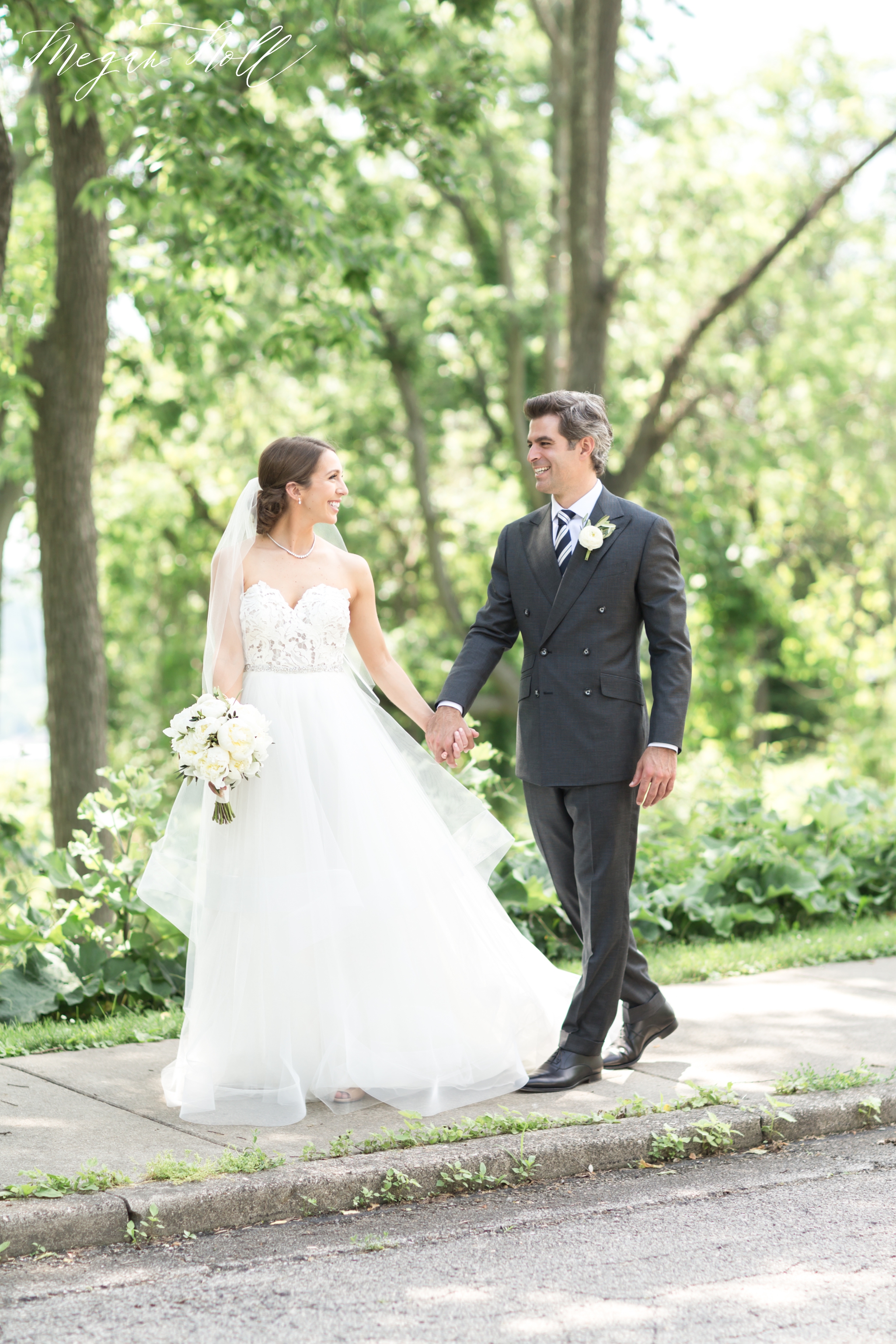 Bride and groom walking to their outdoor wedding reception in Cincinnati
