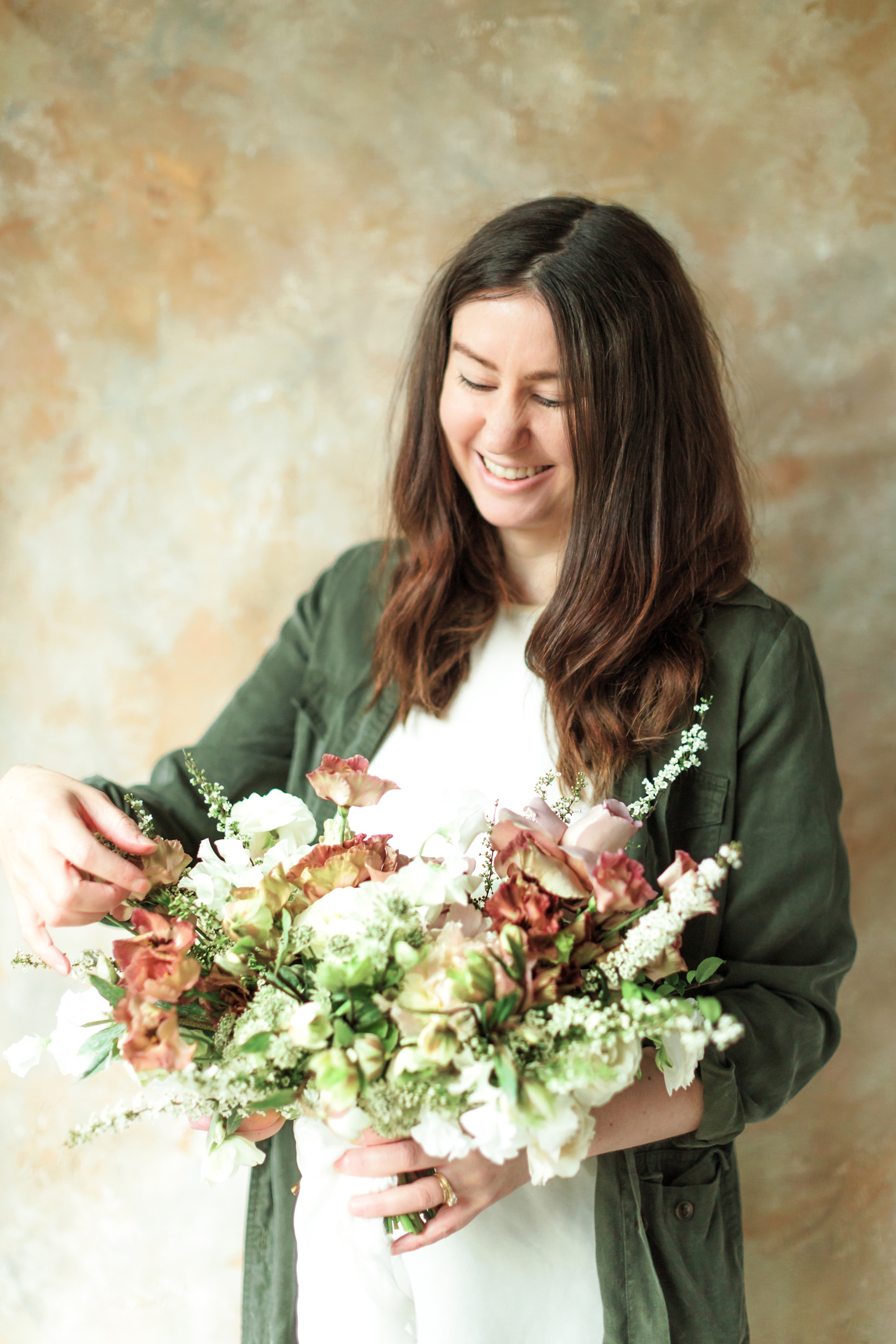 Roots Floral Design owner, Kaytee Stice arranges a wedding bouquet