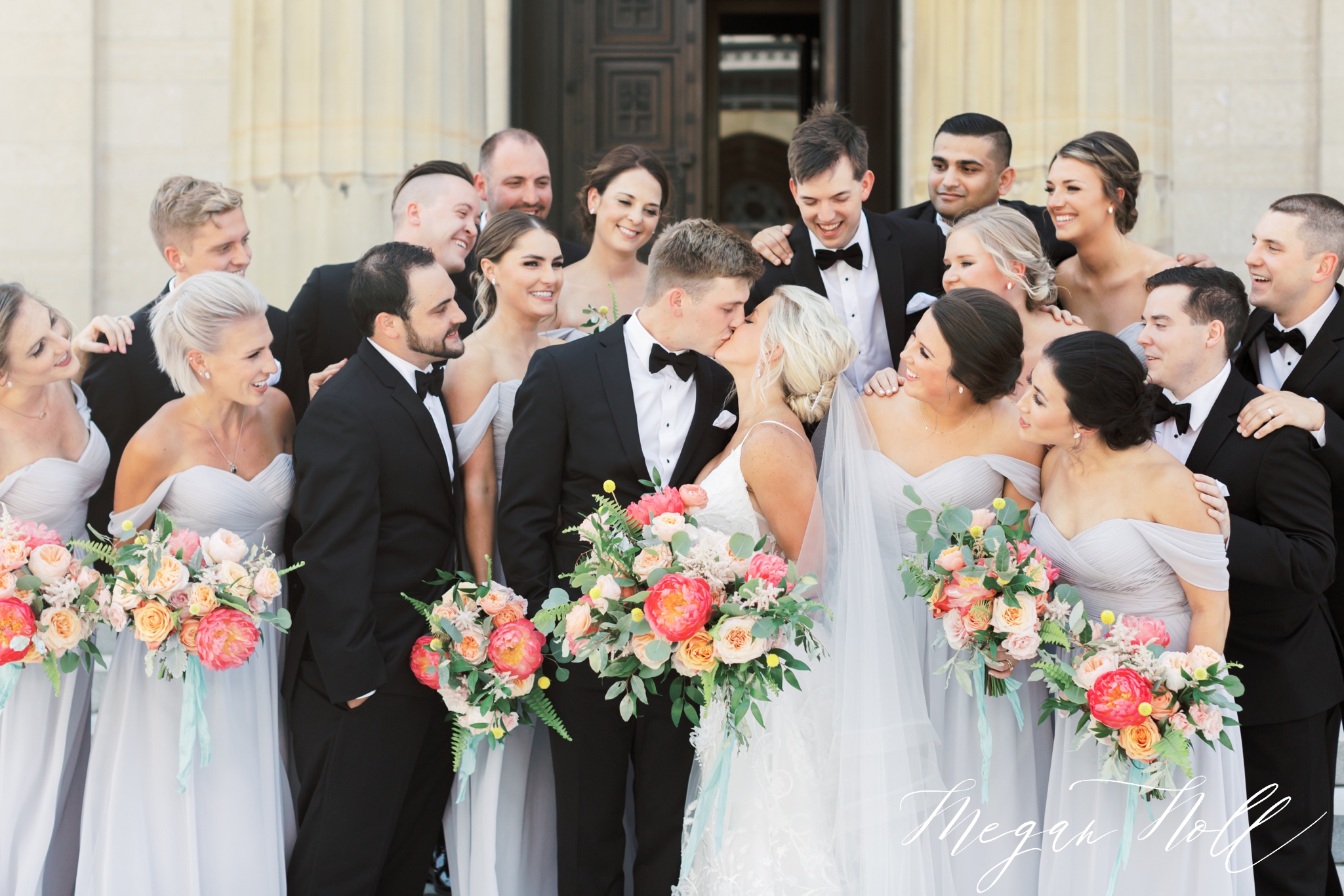 Bridal Party in Cincinnati surrounding couple while they kiss