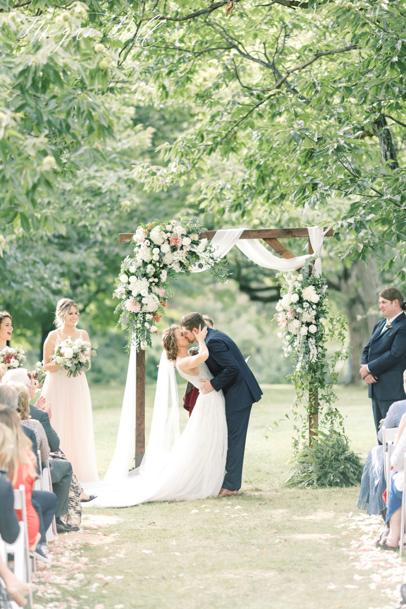 First kiss under gorgeous floral arc by Robin Wood Florals