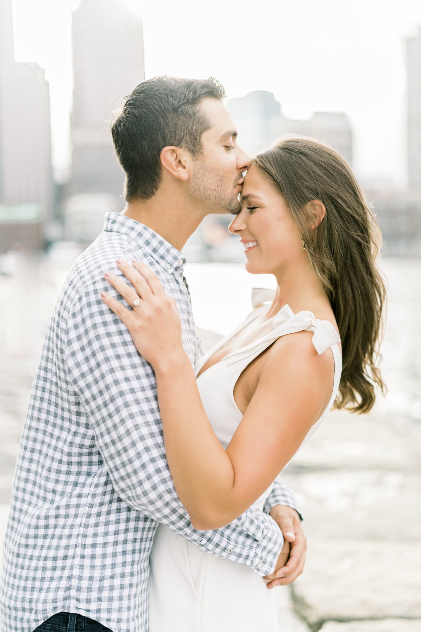 Forehead kiss in boston harbor engagement session
