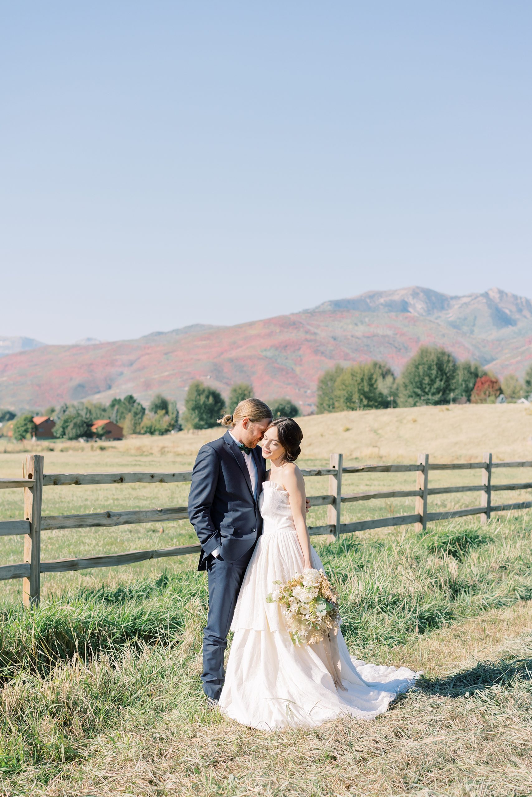 Couple poses at Utah wedding at River Bottoms Ranch