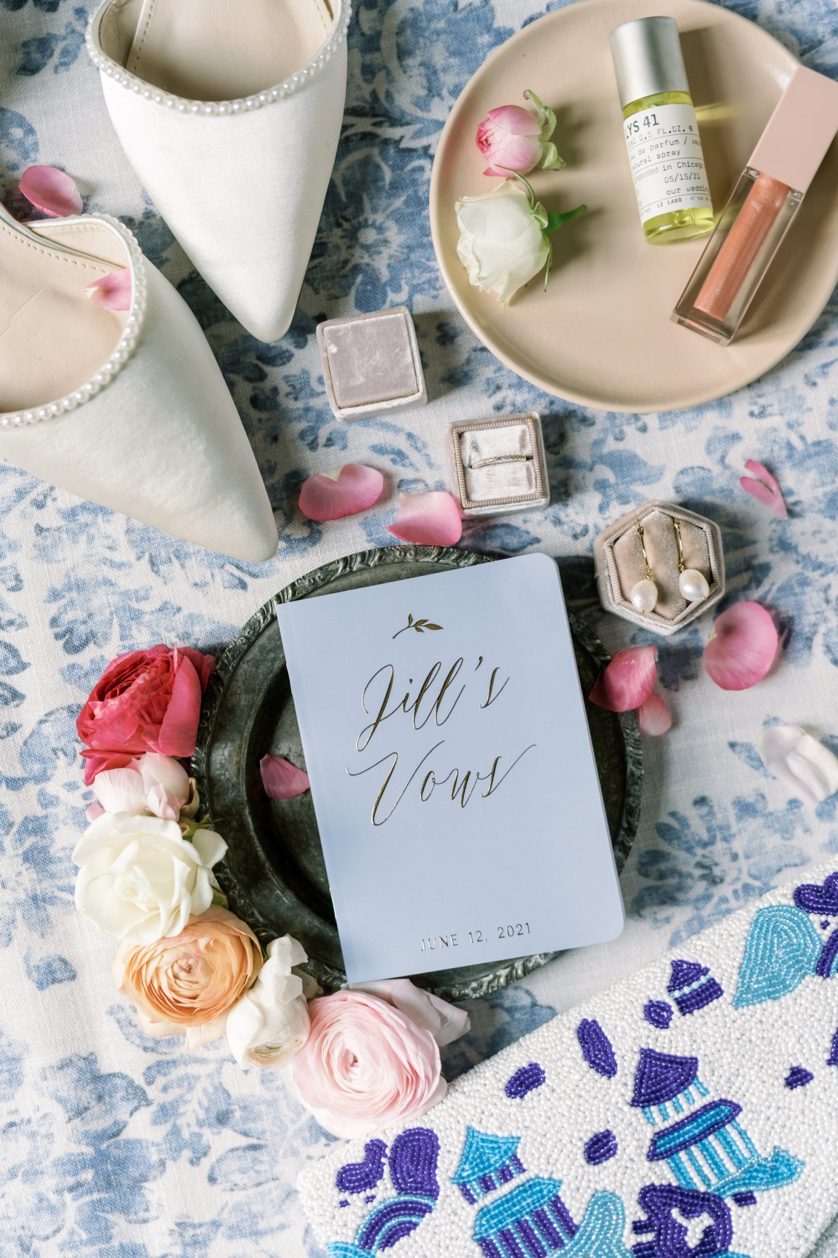 the wedding day details featured colorful florals and vow books