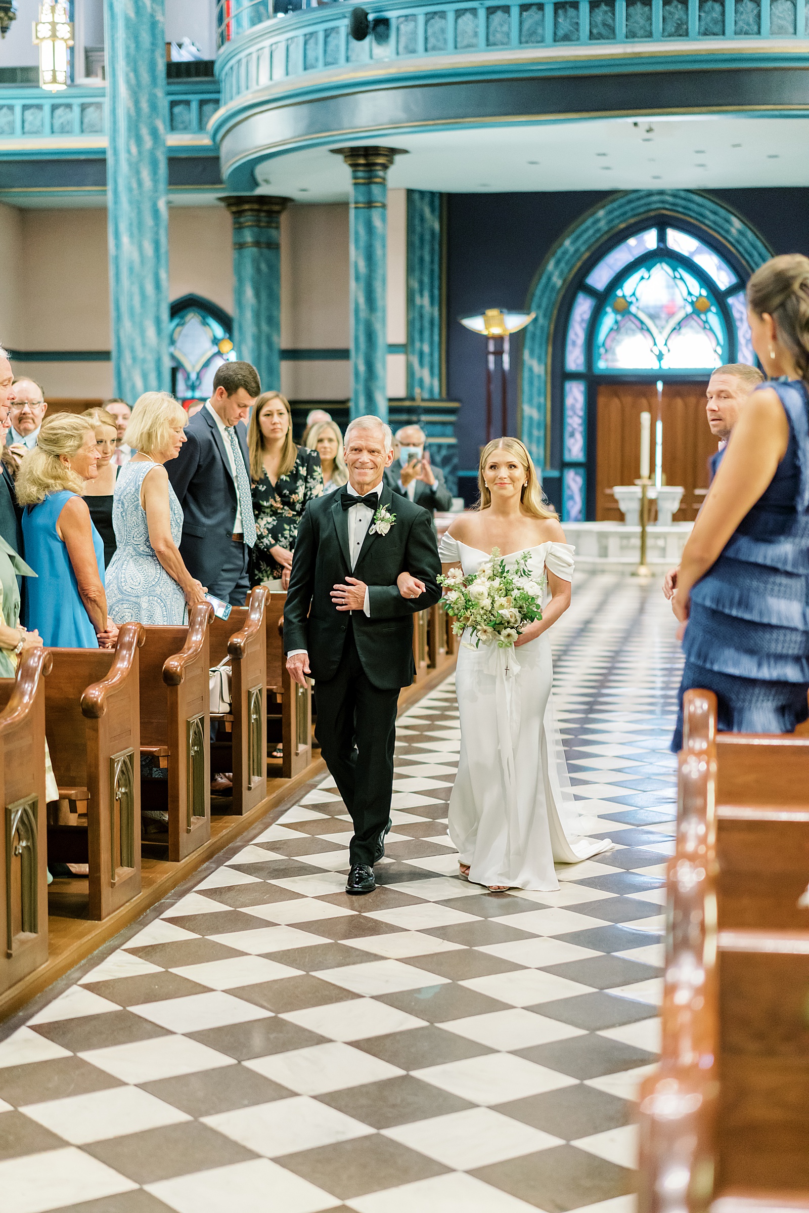 Bride and dad walking down the aisle at Cincinnati Wedding being held at St. Xavier Catholic Church 