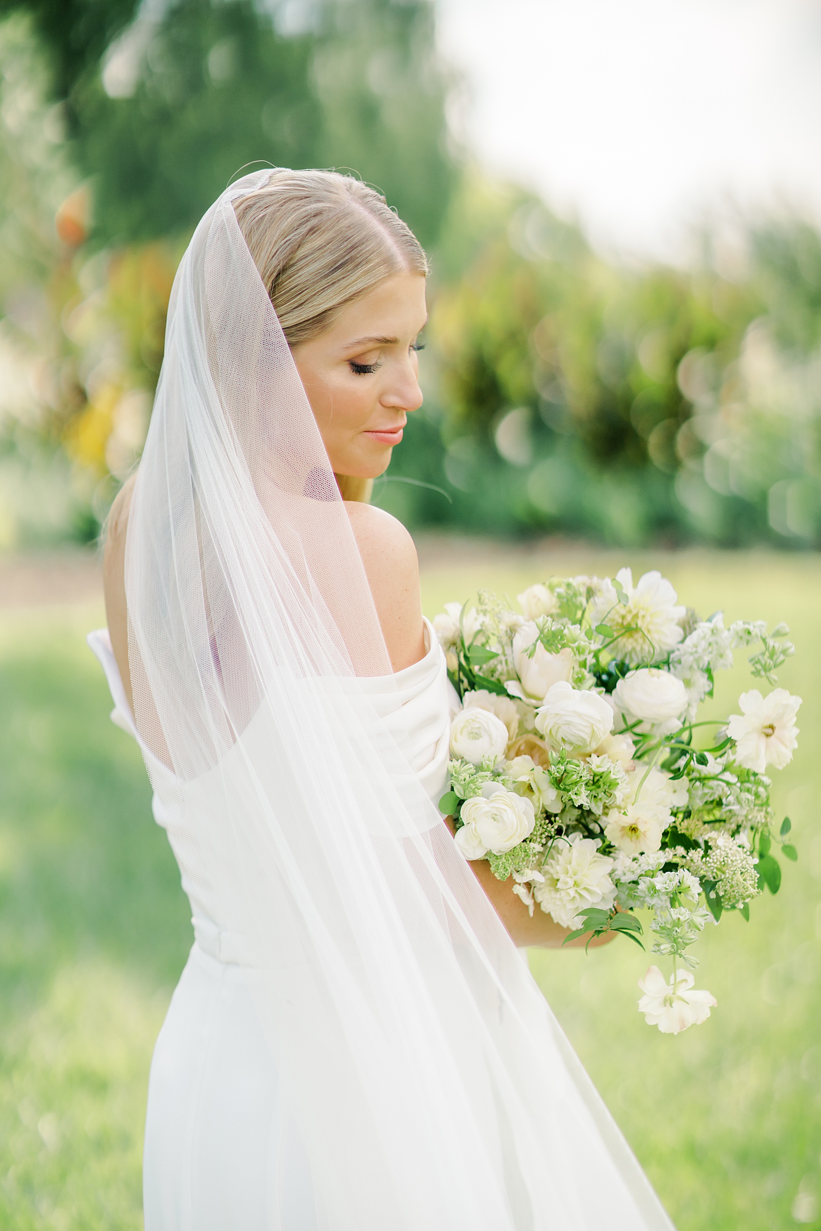 Bride looking over shoulder for Cincinnati Wedding Photographer Megan Noll
