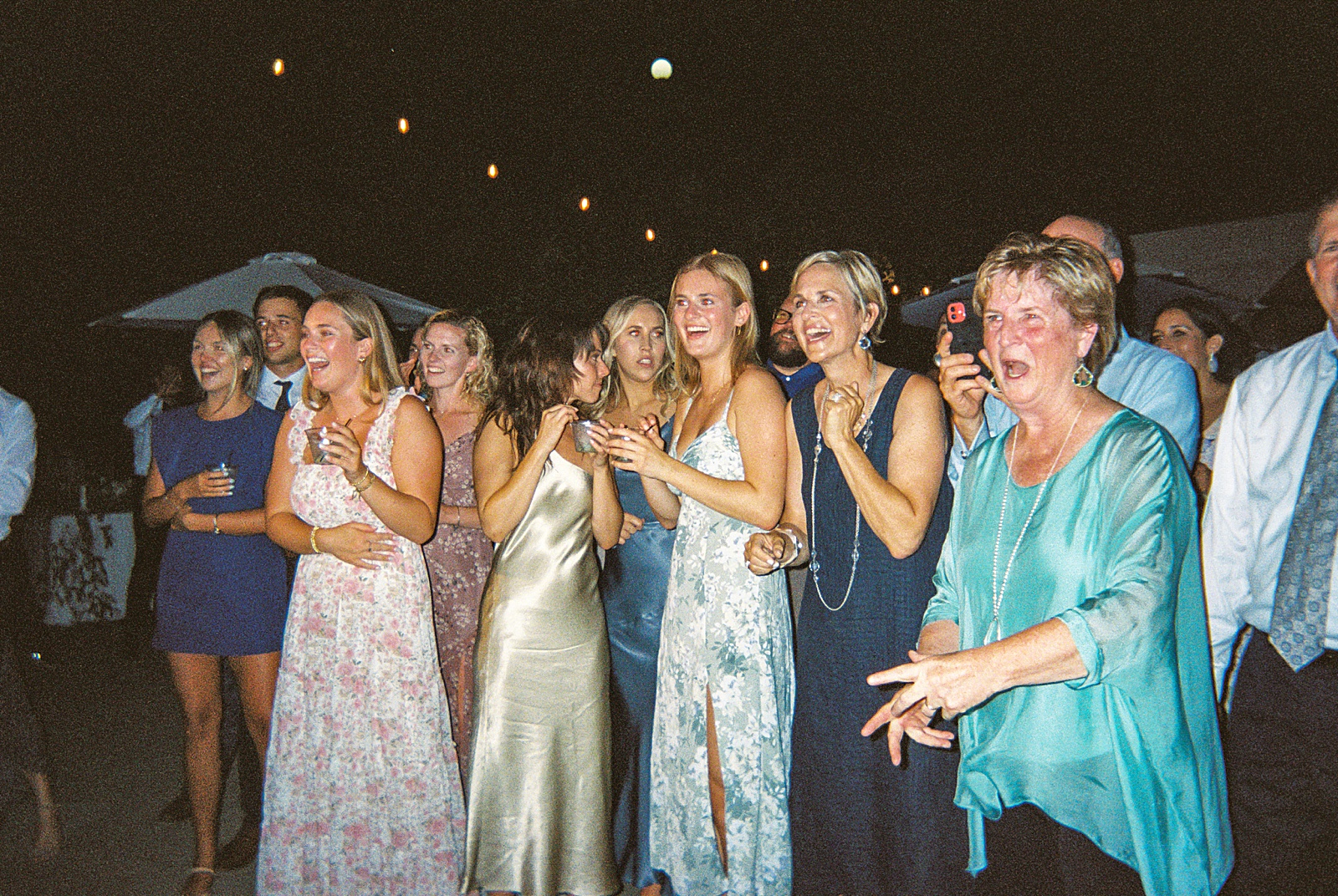 Film pictures of guests enojying dancing at wedding reception