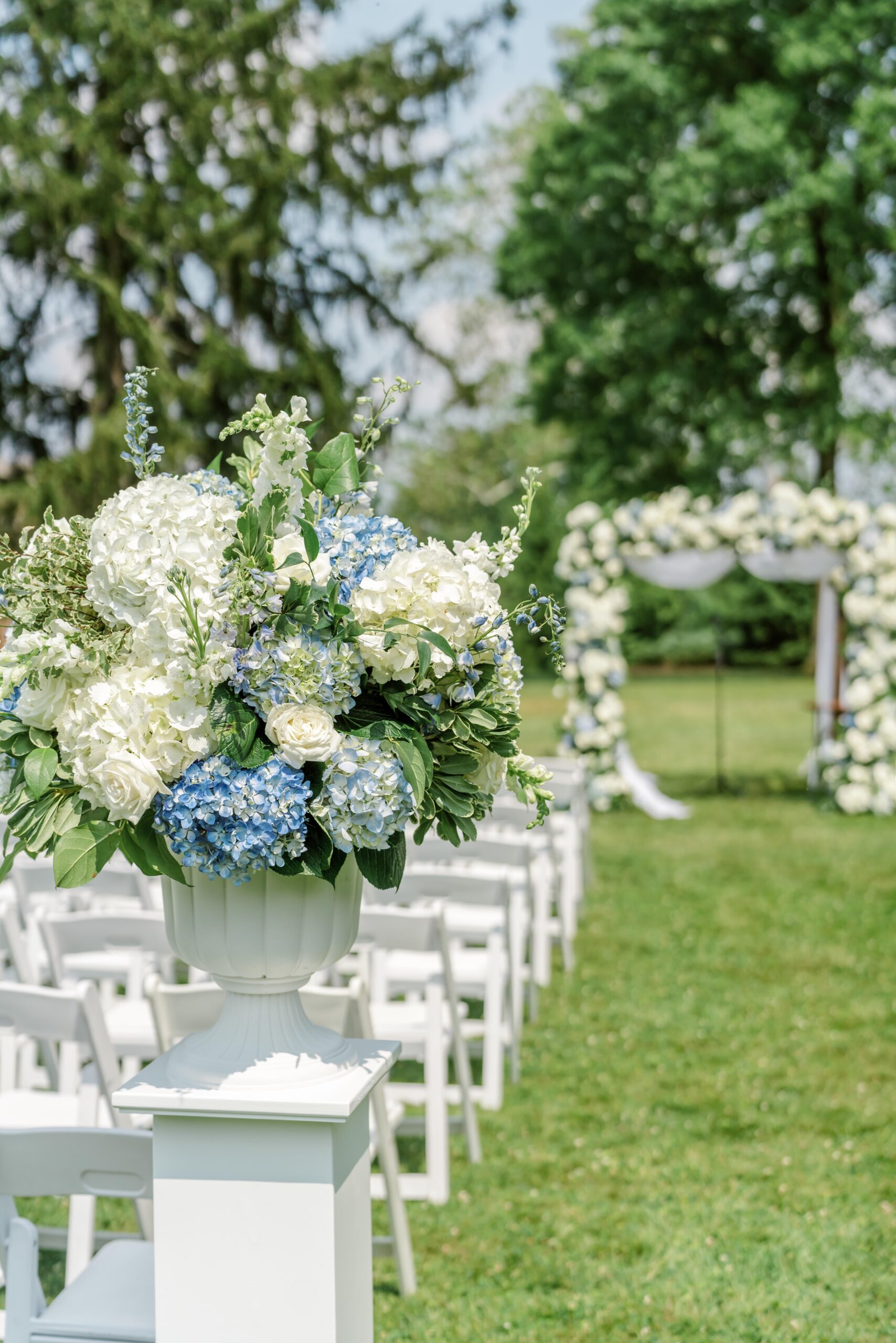 Blue and white hydrangeas at the outdoor wedding ceremony