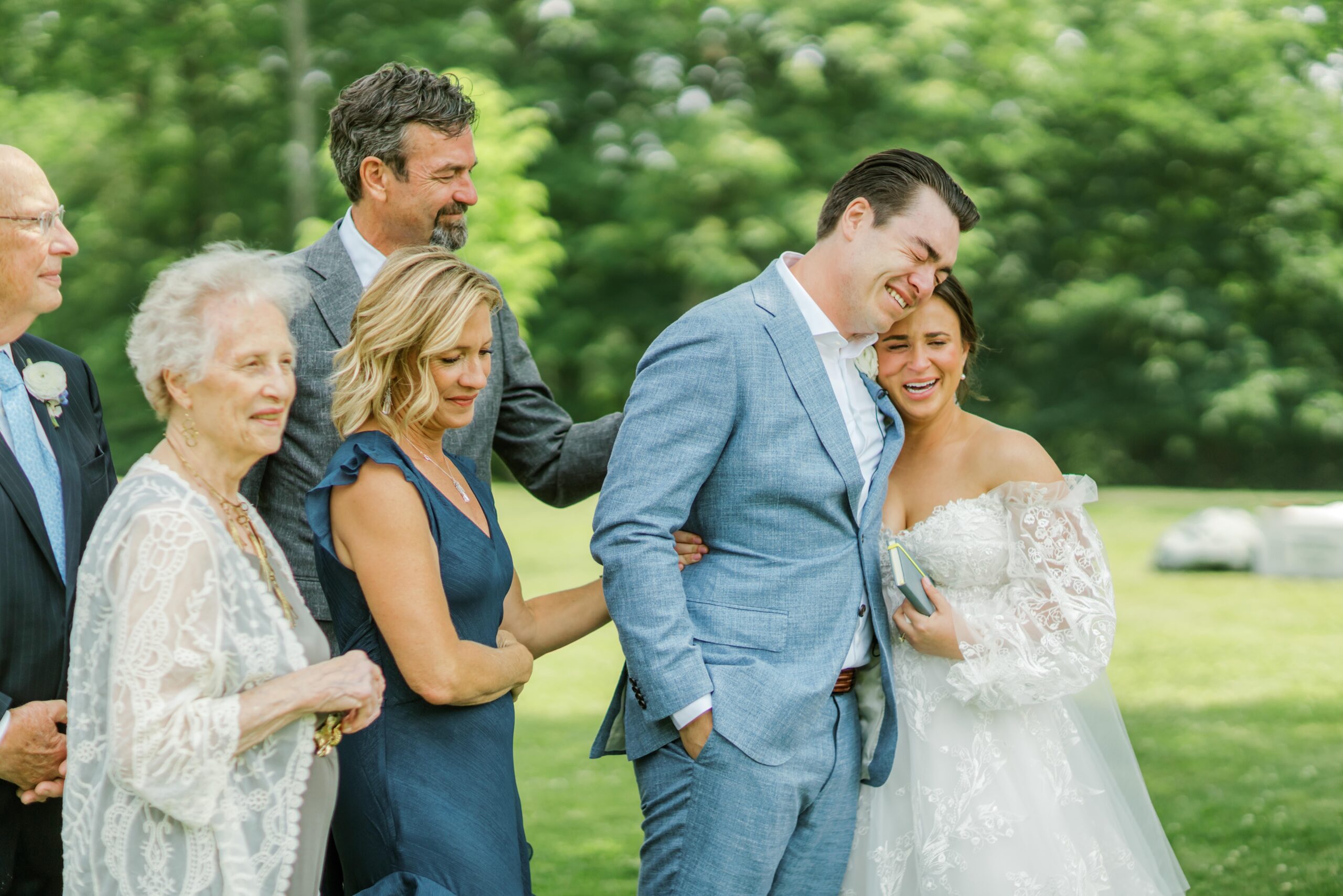 Bride and groom hug with family at the Pittsburgh wedding
