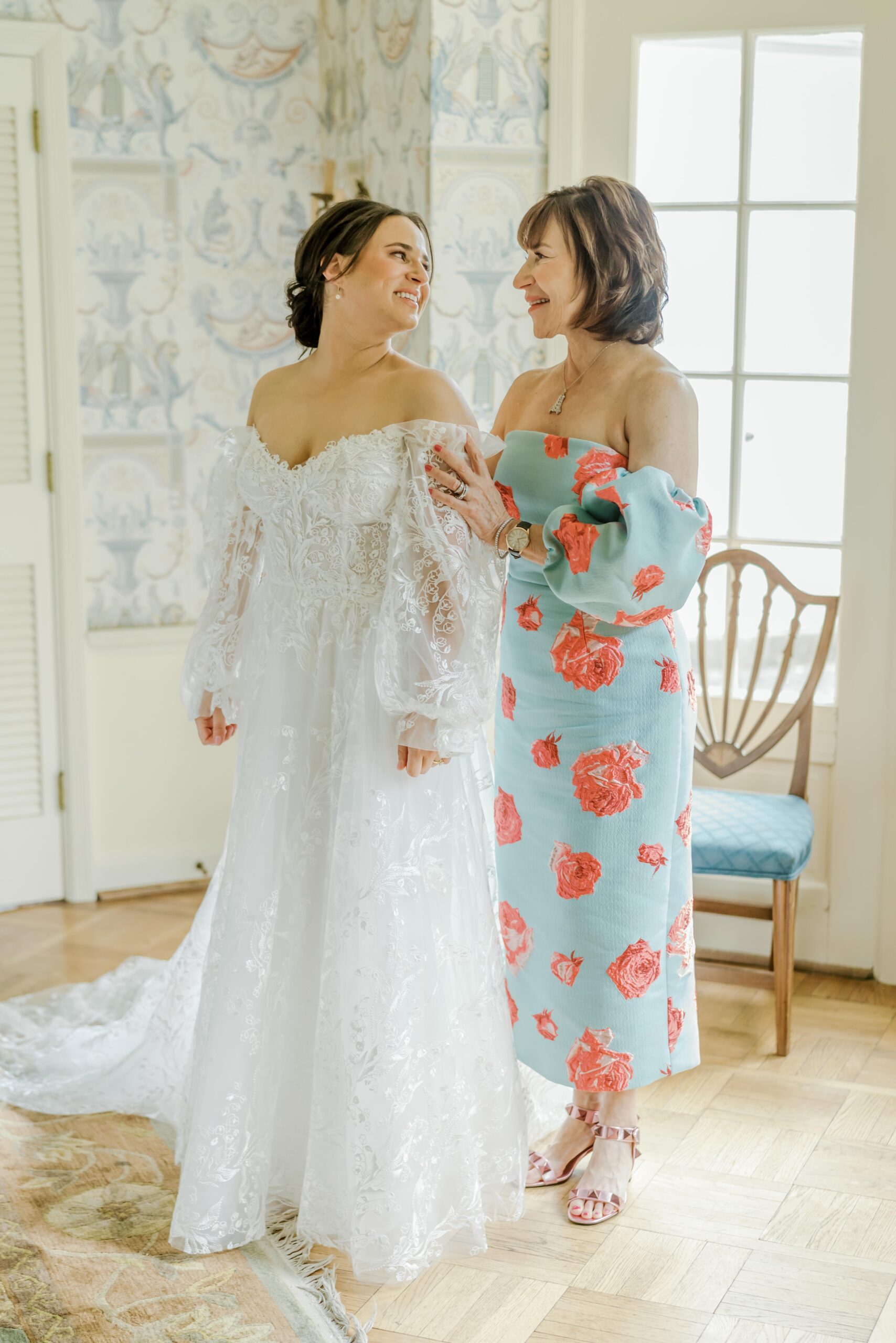 Mother of the bride helps the bride into her dress at the Pittsburgh wedding