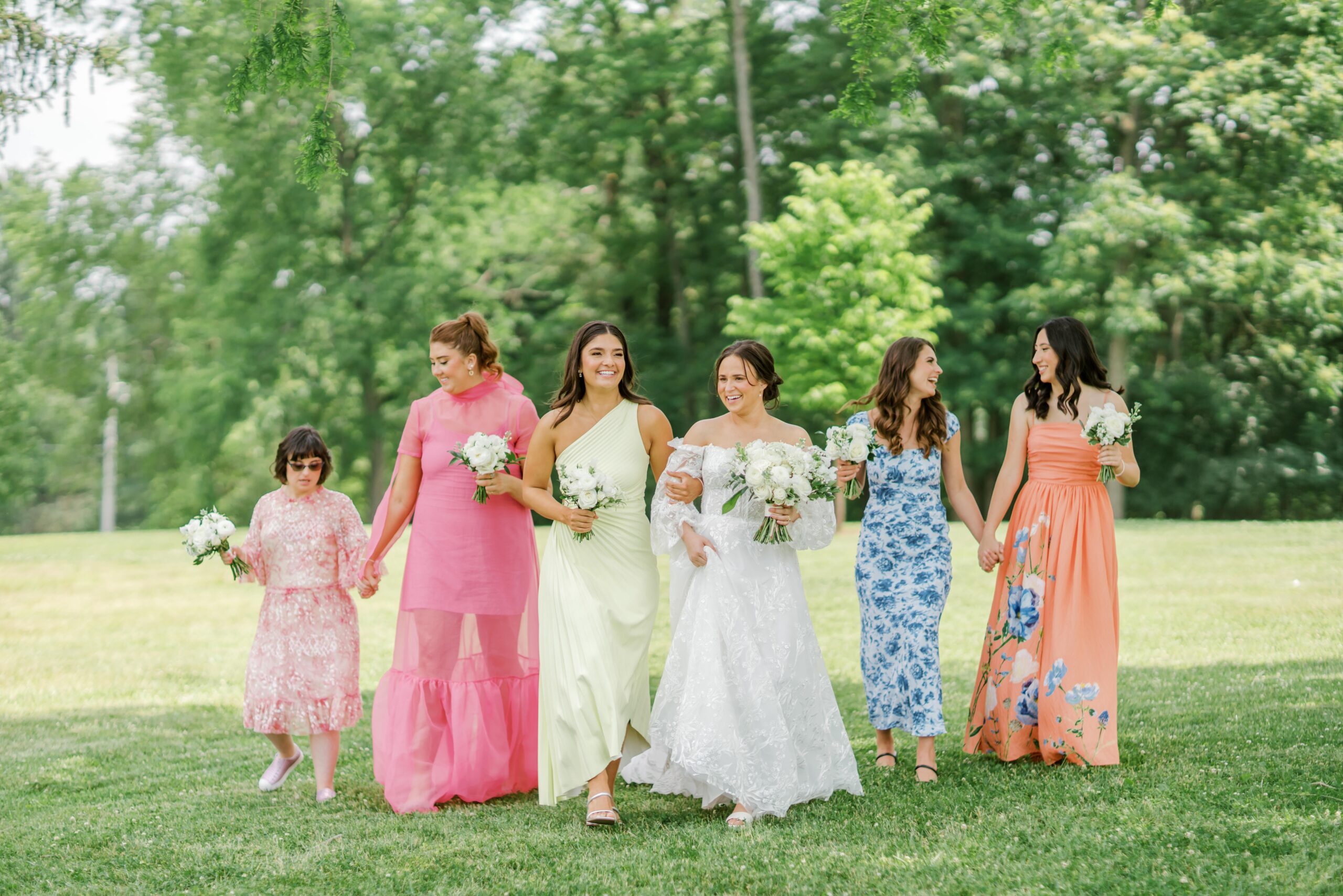 Bride with bridesmaids in mismatched bridesmaids dresses