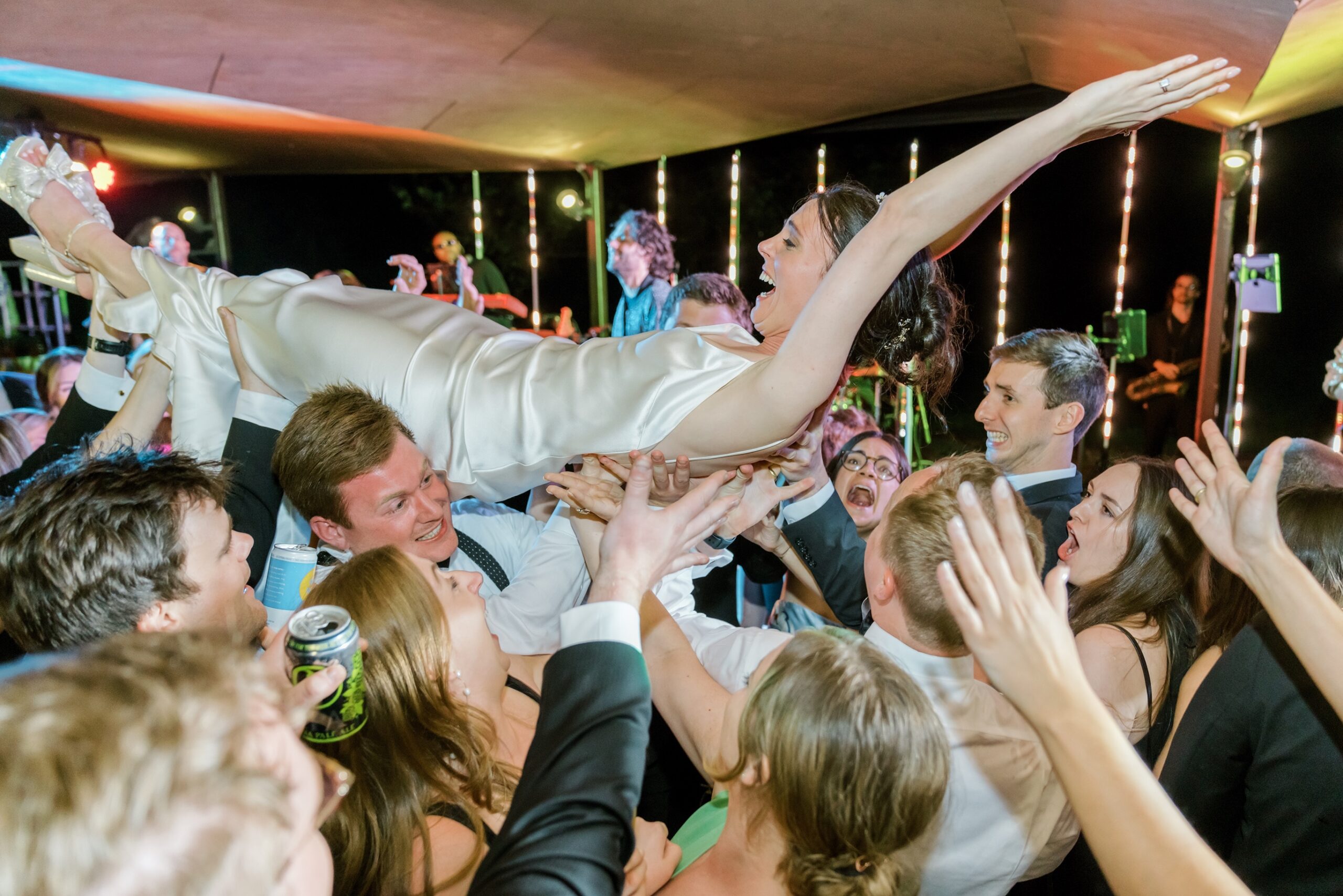 Bride lifted into the air at the Yew Dell Gardens wedding reception