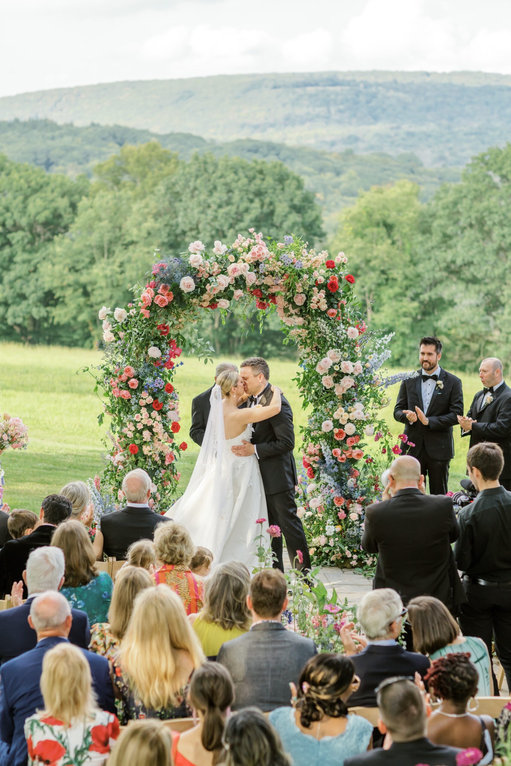 Bride and groom kiss at Pocono Mountain wedding ceremony