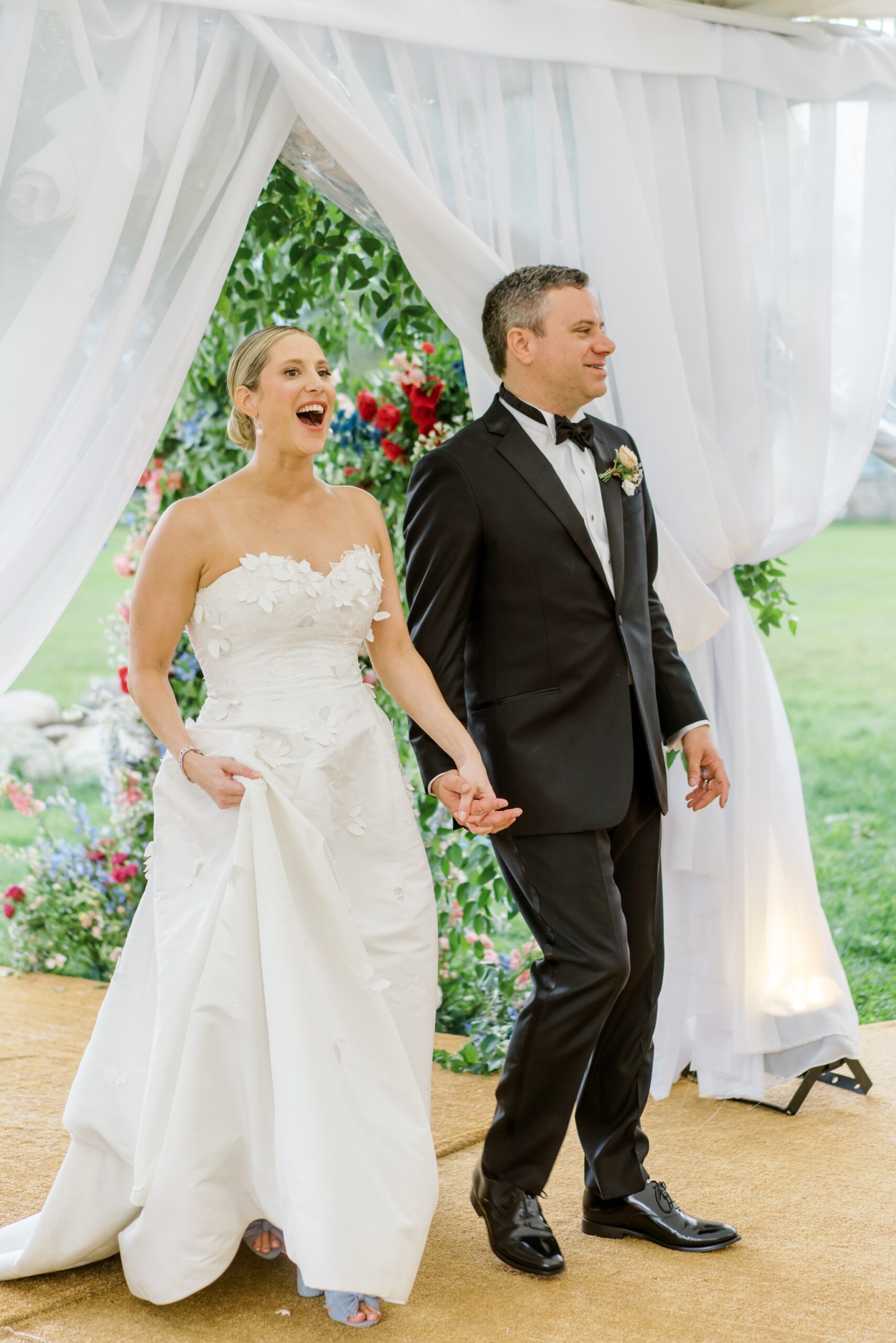 Bride and groom react to the Pocono Mountain wedding reception tent