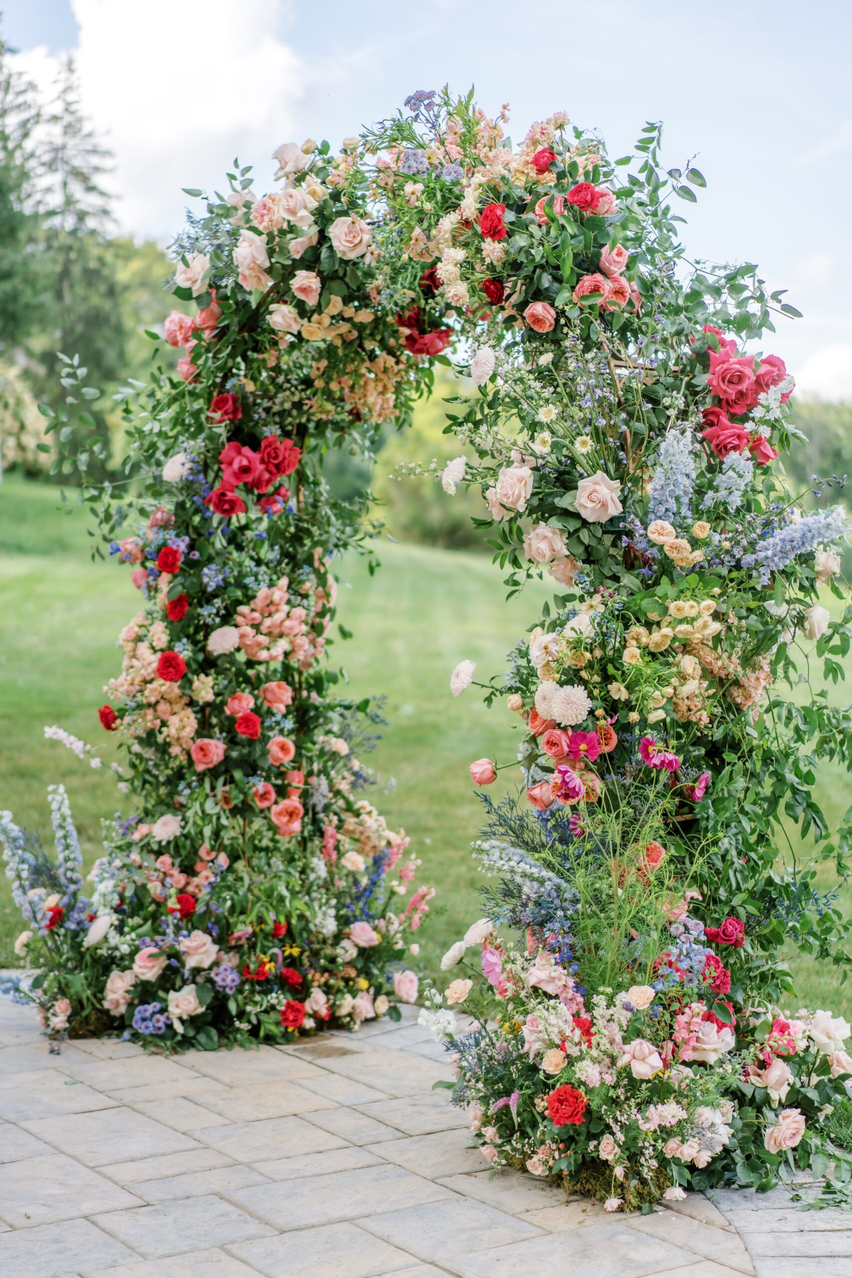 Colorful, textured wedding ceremony floral arch