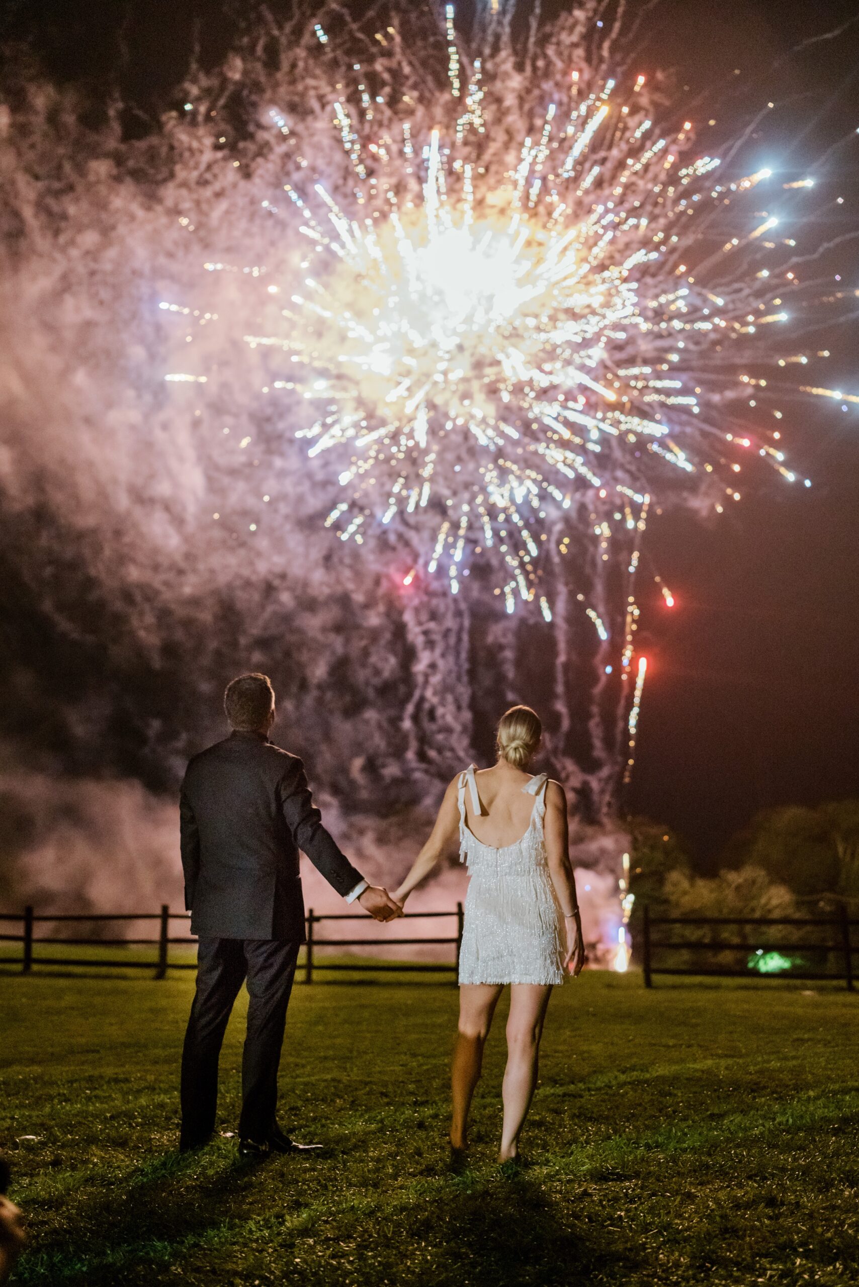 Bride and groom watch fireworks at the Pocono Mountain wedding reception