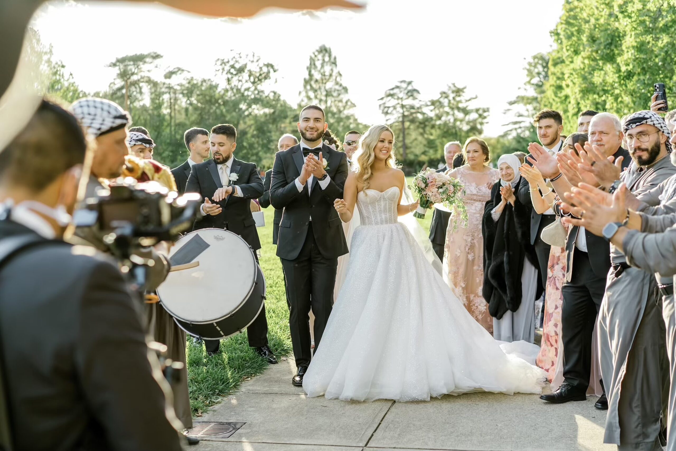 Bride and groom with performers at Ault Park wedding