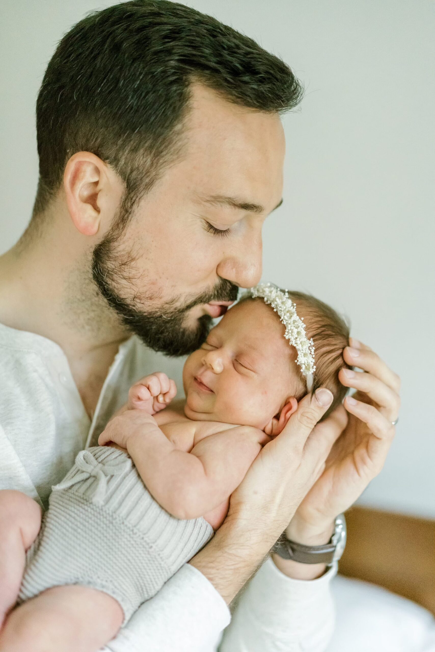 Dad kisses newborn baby's head