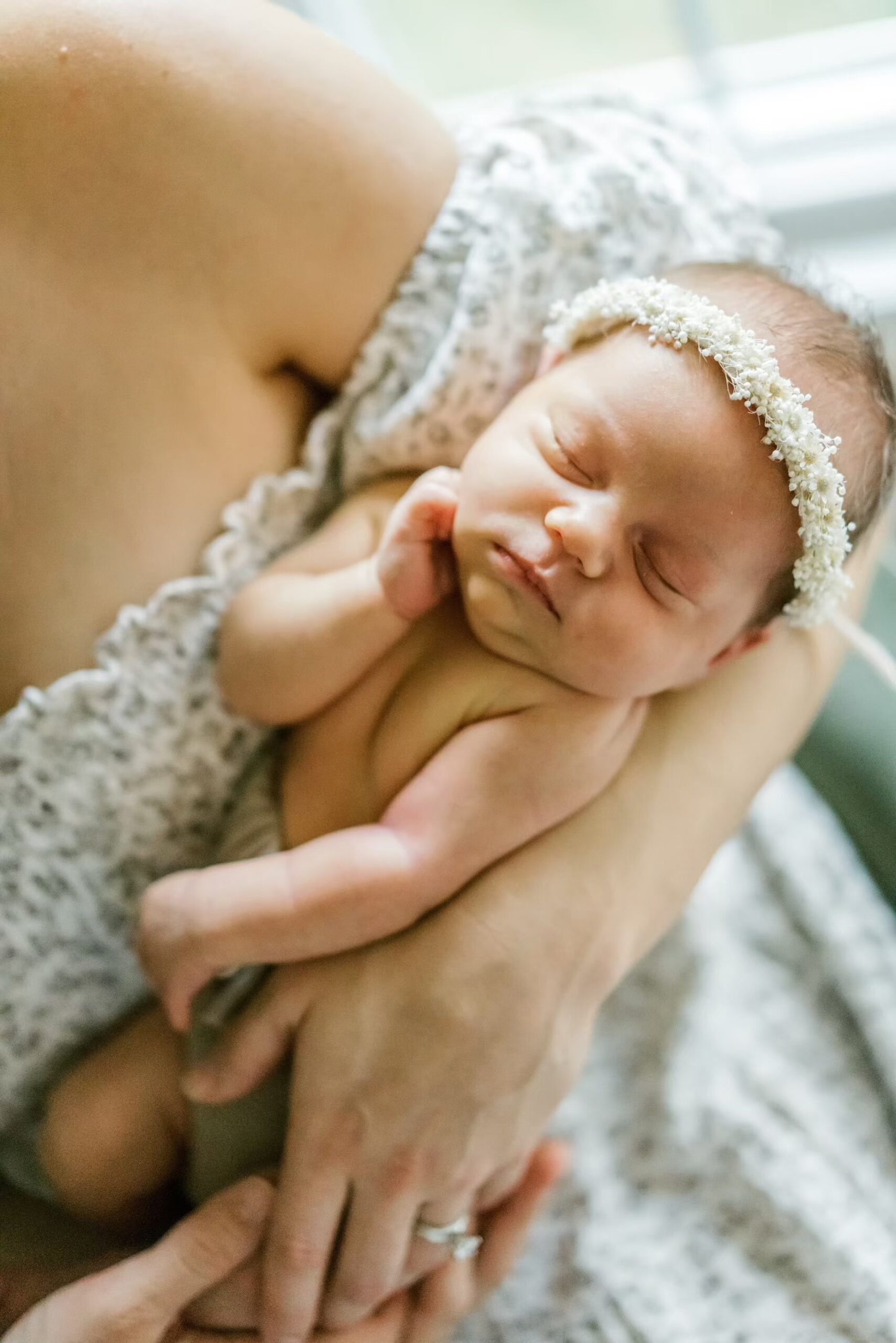 Close up of newborn baby with flower headband