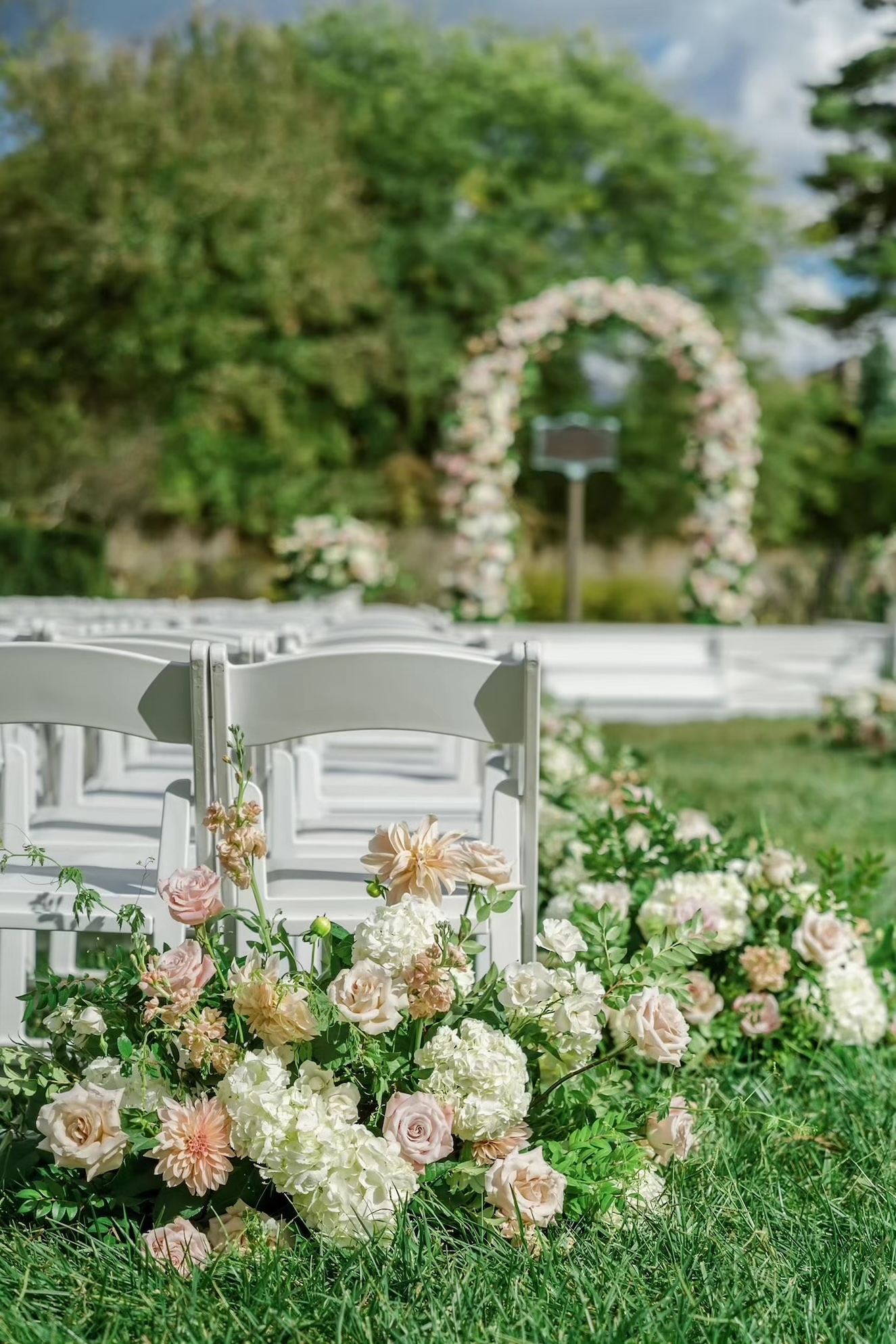 Wedding aisle arrangements with pink and white florals
